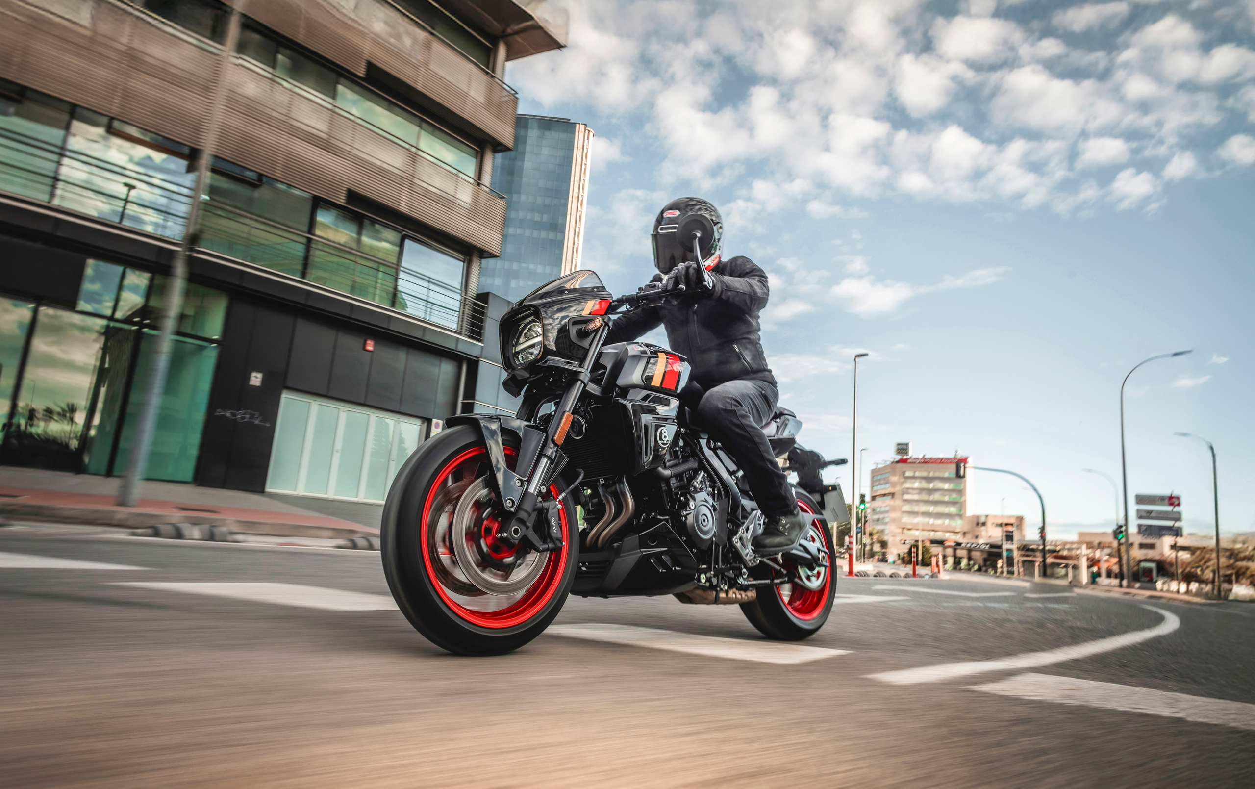 Suzuki GSX-8TT black, riding through a city environment