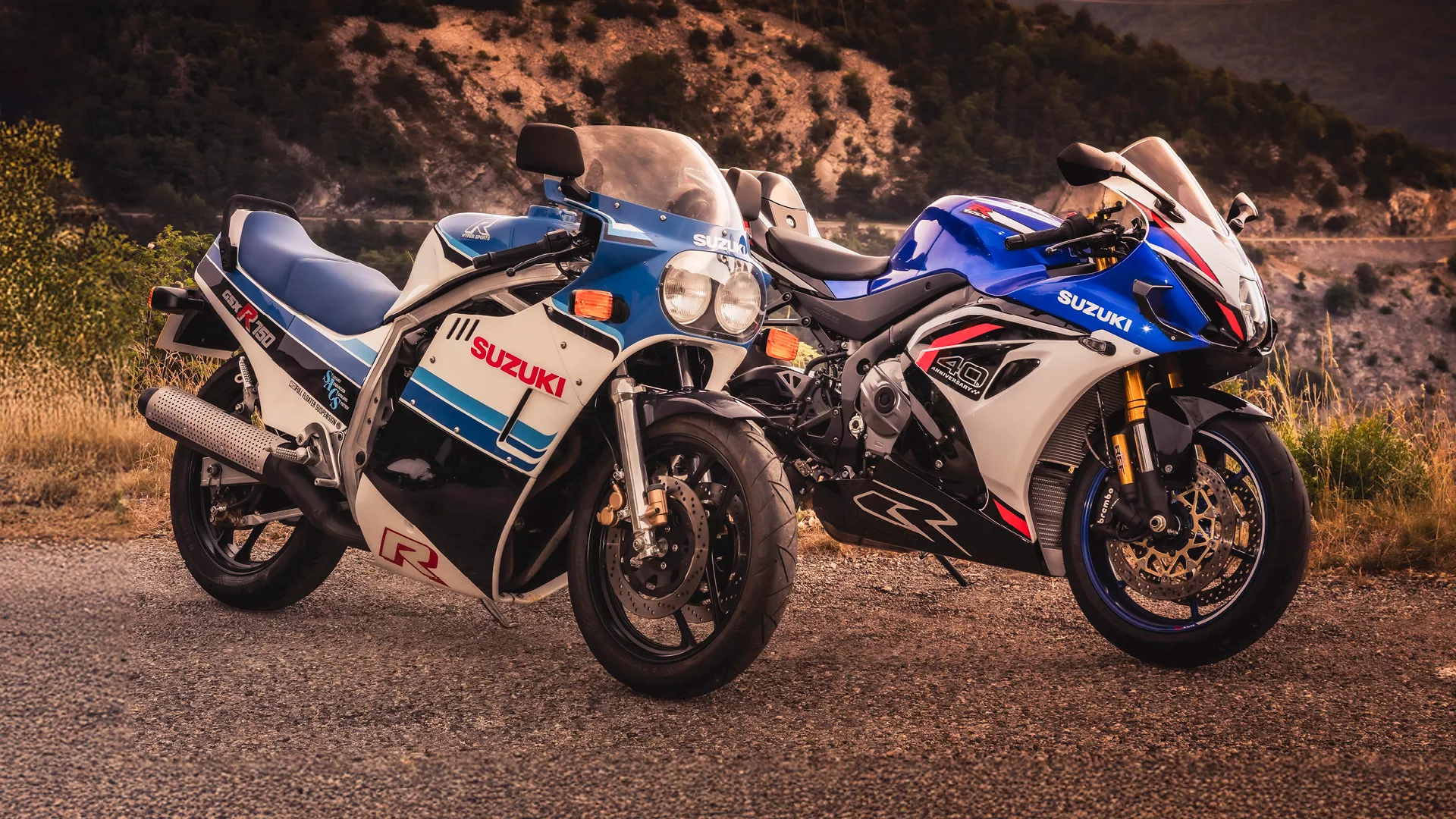 Suzuki GSX-R1000R and classic GSX-R750 on a mountain side road at dusk