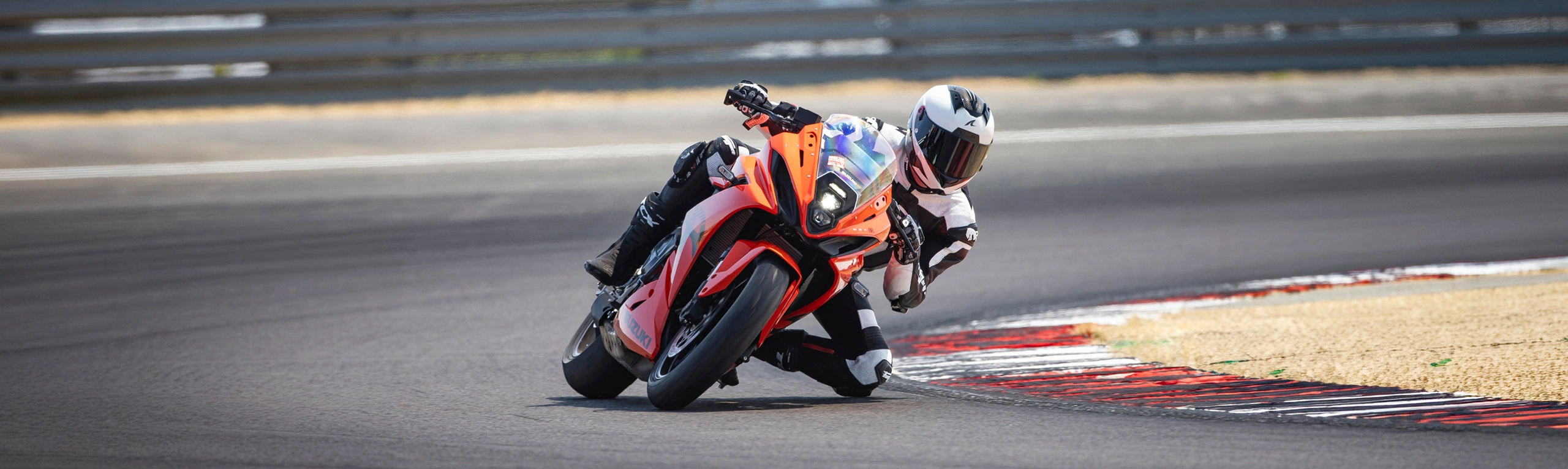 Suzuki GSX-8R orange on track pushing hard through a corner