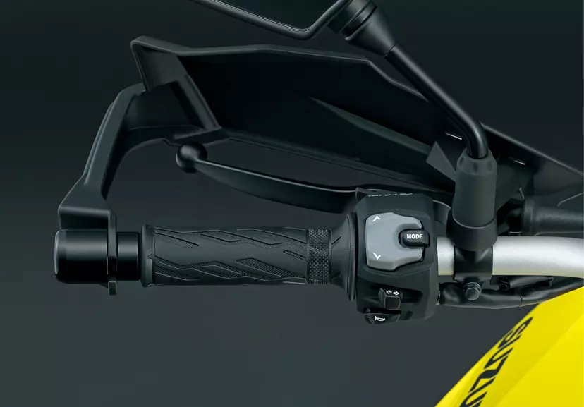 A detailed view of the Suzuki V-Strom 800DE’s mode selector switch on the left bar