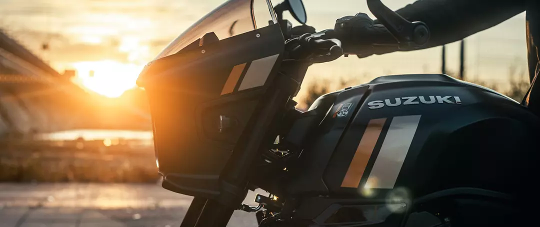 Suzuki GSX-8TT close up of front cowling and tank, left hand side, with sunset background