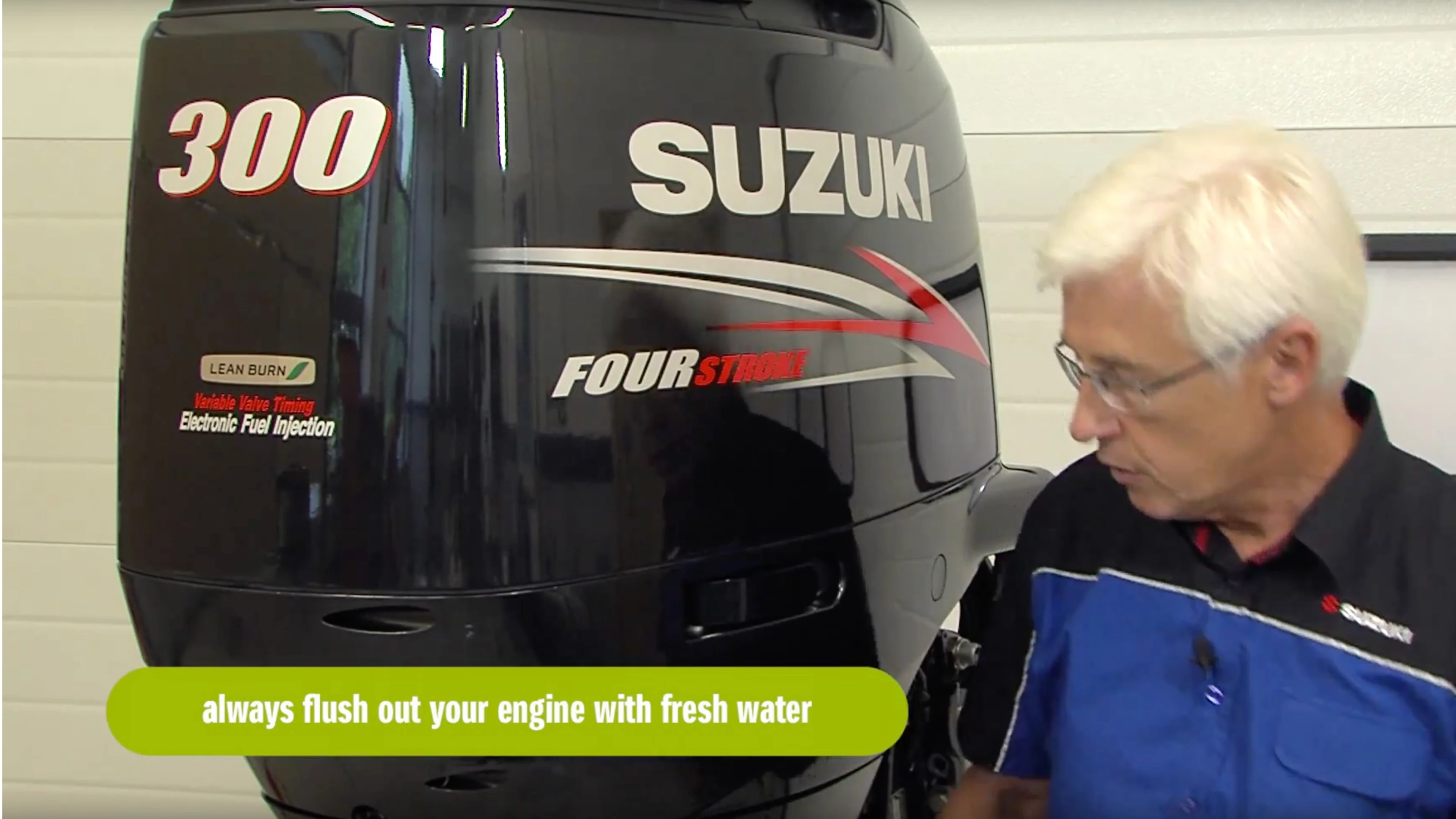 An engineer glancing at their Suzuki outboard with a manuscript in hand.