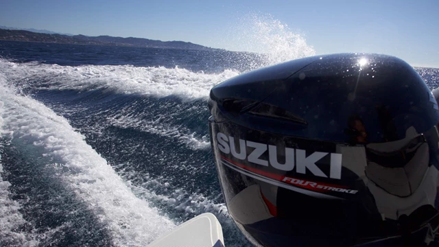 A Suzuki outboard causing a wake.