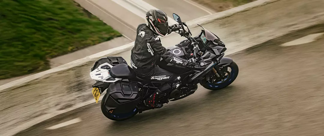 Suzuki GSX-S1000GX+ riding over a bridge with water underneath
