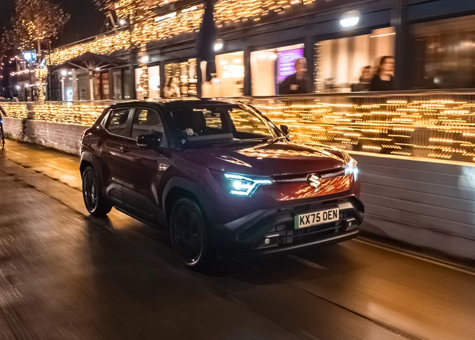 Suzuki e Vitara Driving Through City At Night
