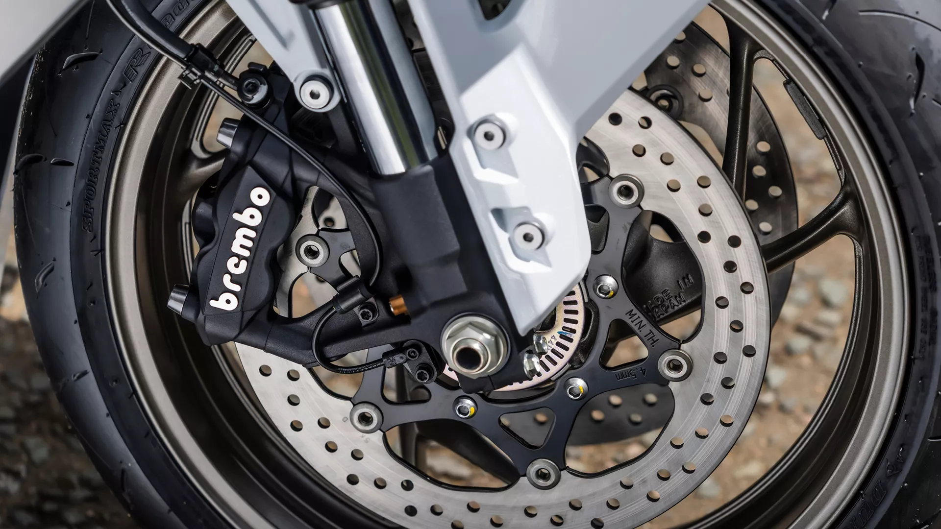 Suzuki GSX-S1000GT+ front tyre and brakes close up.