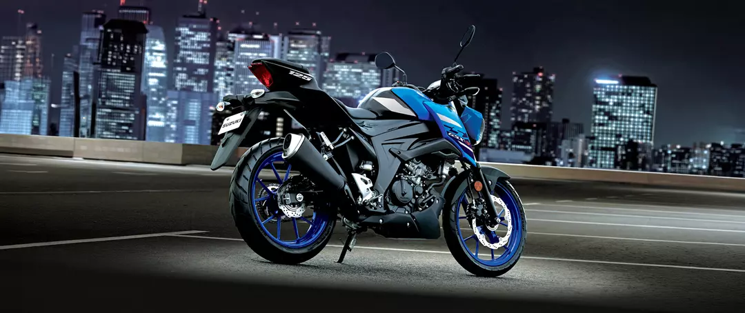 Suzuki GSX-S125 exhaust side on with a city at night background. 