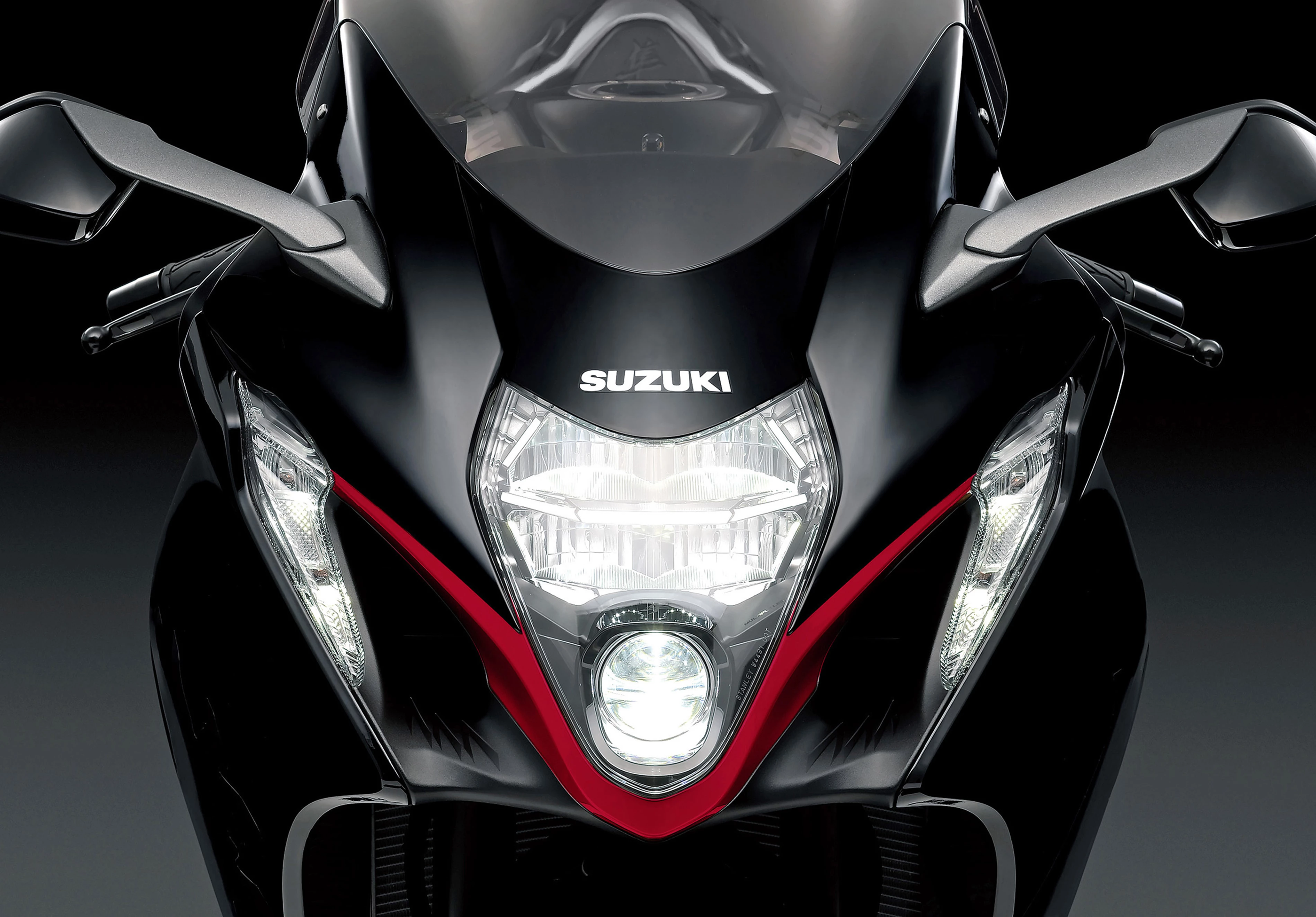 Suzuki Hayabusa head on with the headlight illuminated. 
