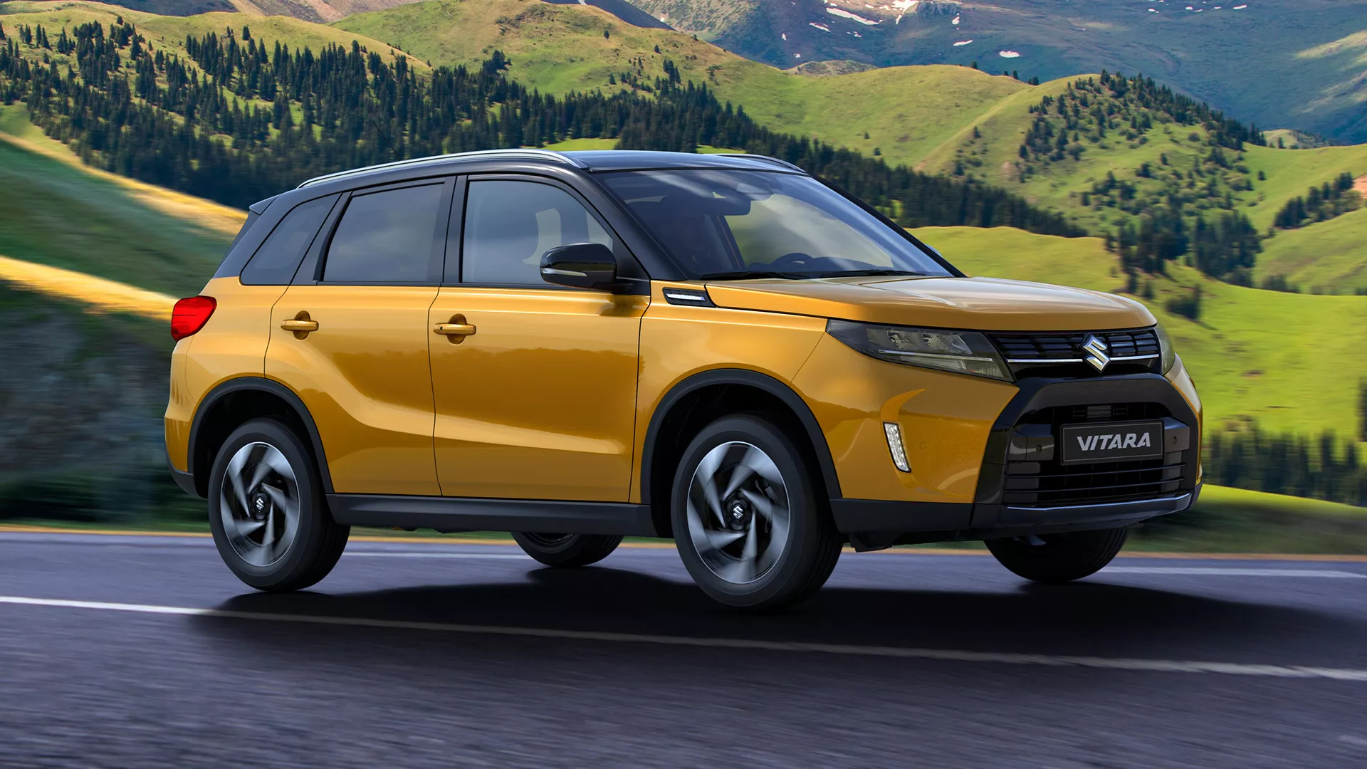 Suzuki Vitara in solar yellow driving along a scenic mountain road, showcasing its bold front-side profile and rugged SUV styling.