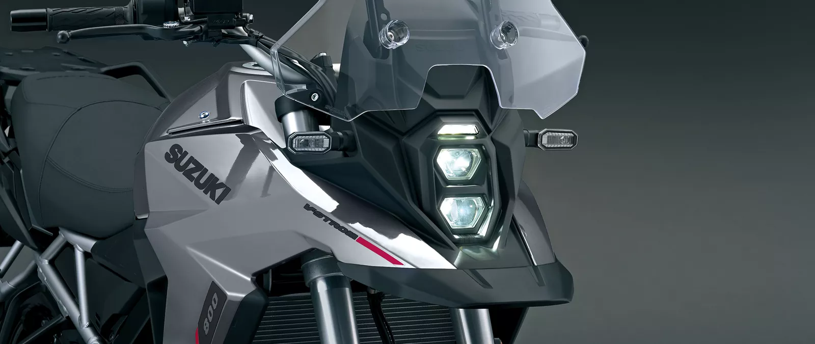 Suzuki V-Strom 800RE grey front on left hand side shot showcasing the front headlights