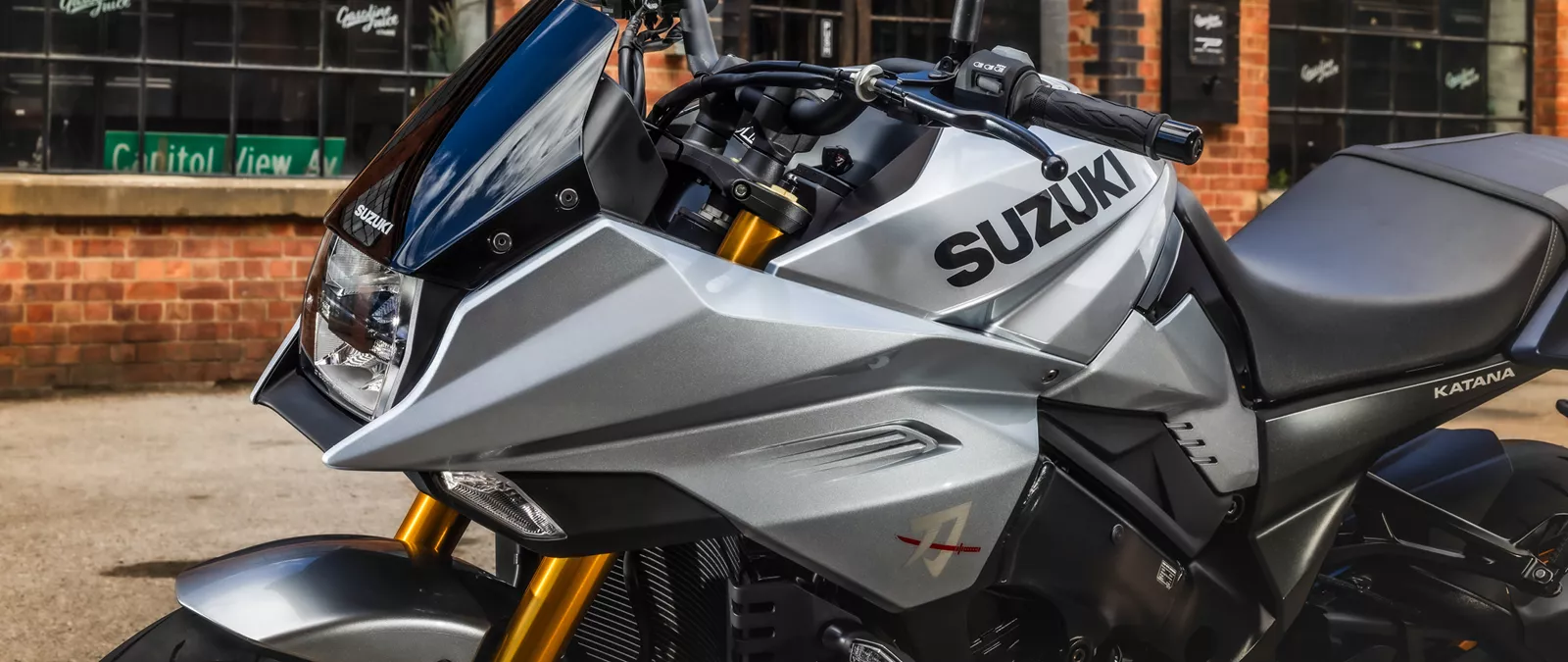 Suzuki Katana silver close up of the left hand side in a city location