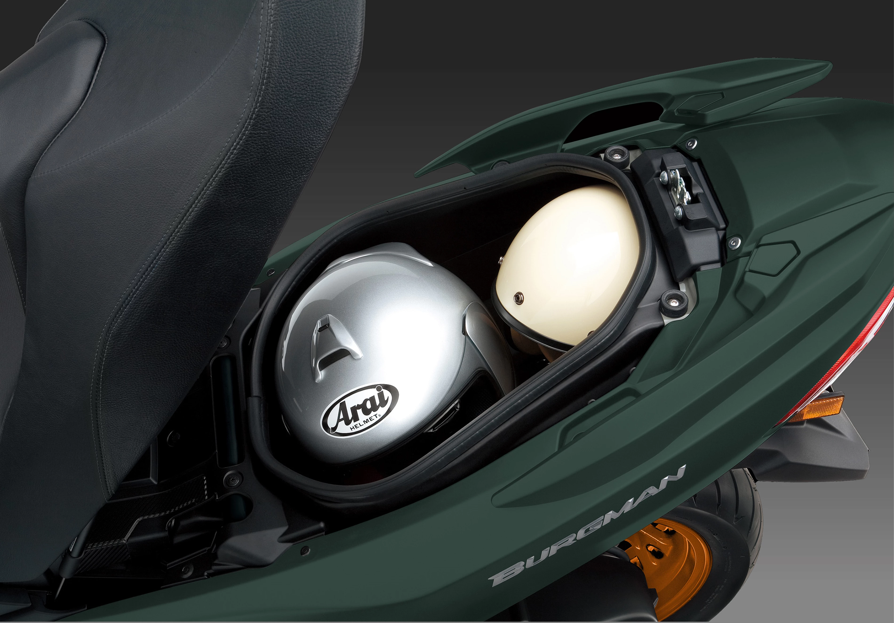 Suzuki Burgman 400 under seat storage opened with two helmets inside