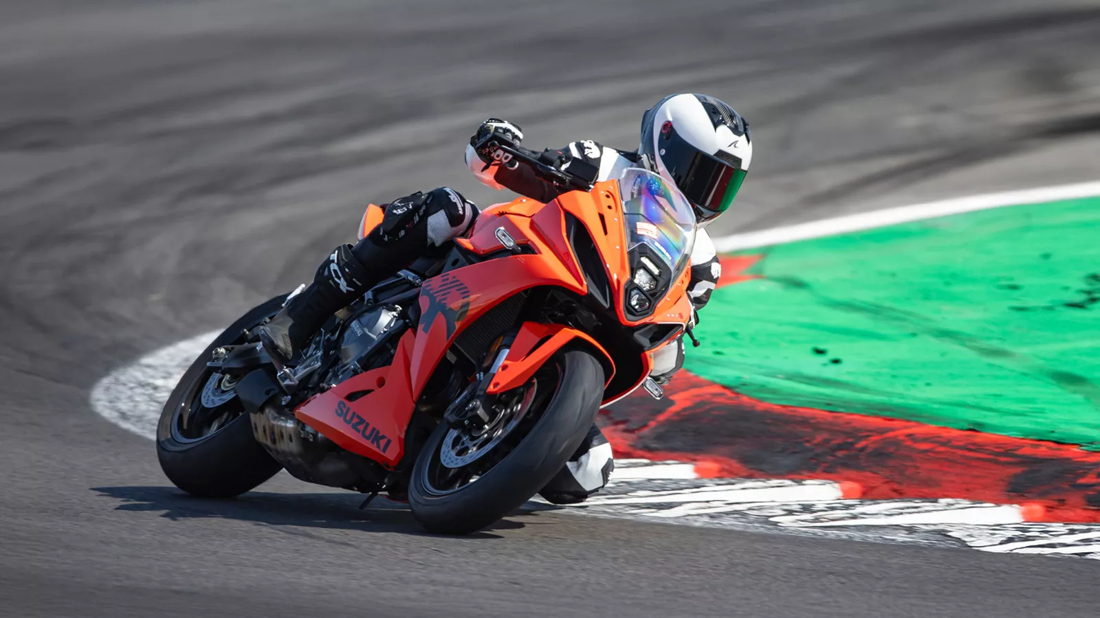 Suzuki GSX-8R orange pushing on out on track coming out of a corner