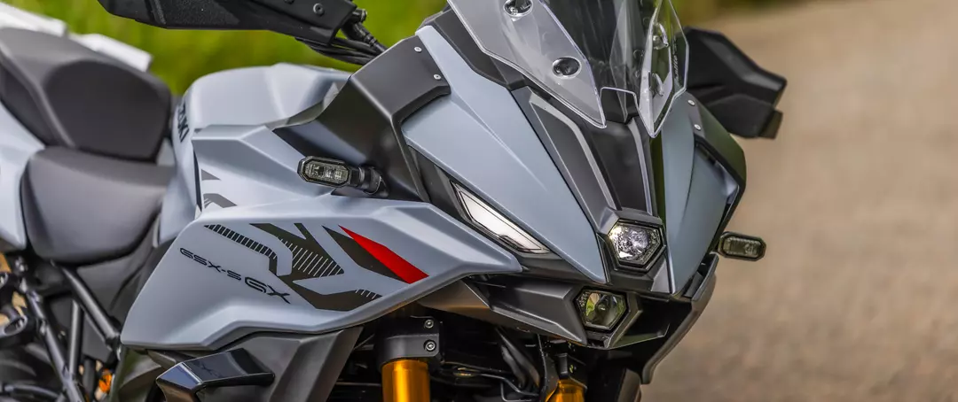 Suzuki GSX-S1000GX+ front end close-up showcasing headlights and winglets.