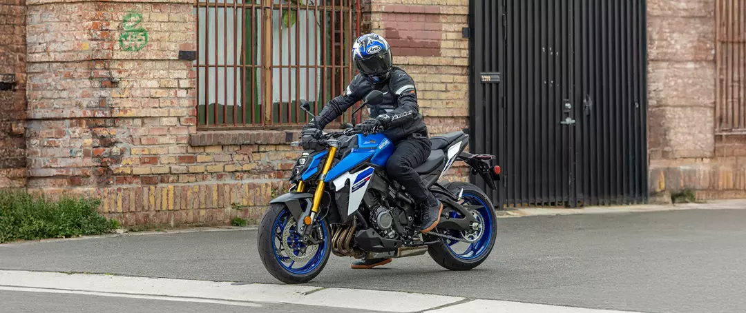 Suzuki GSX-S1000 in blue front three quarters waiting at a junction