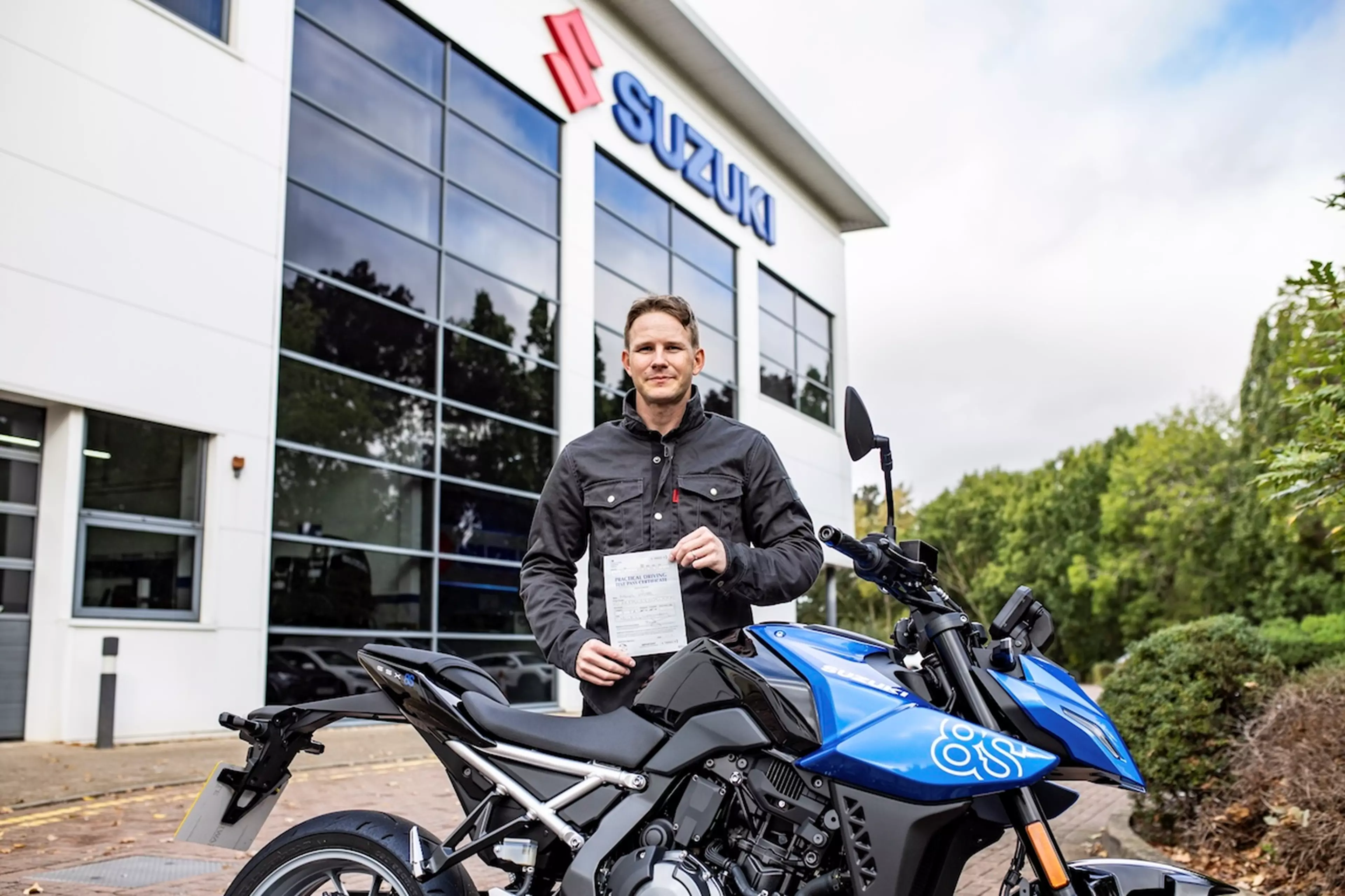 Danny Webb with his certificate and a Suzuki 8S