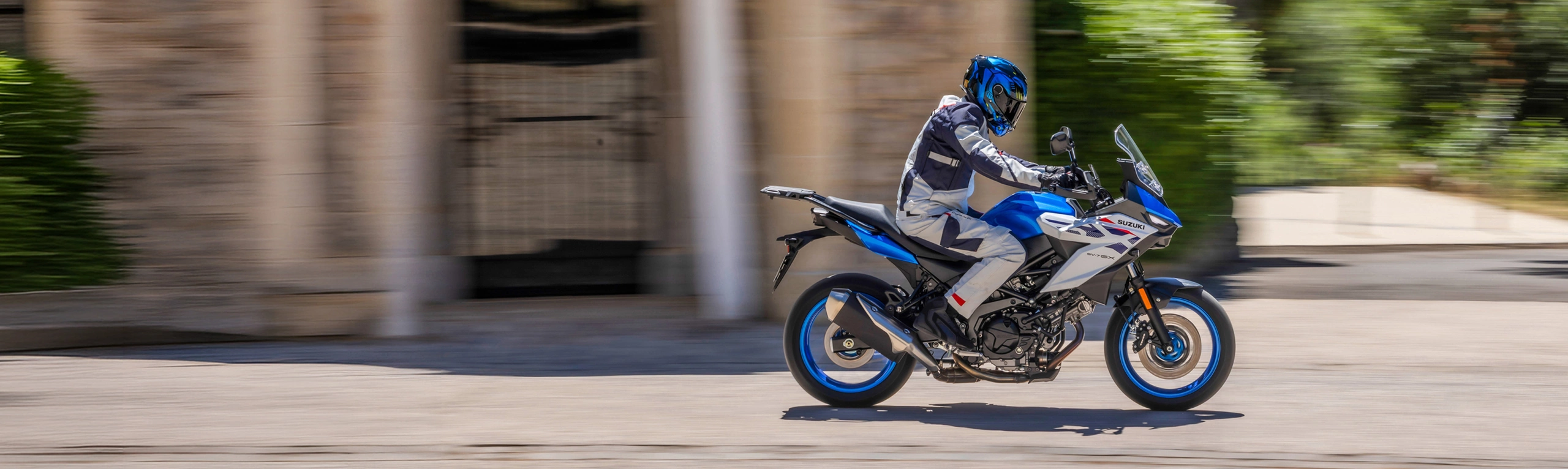Suzuki SV-7GX blue, moving through town.