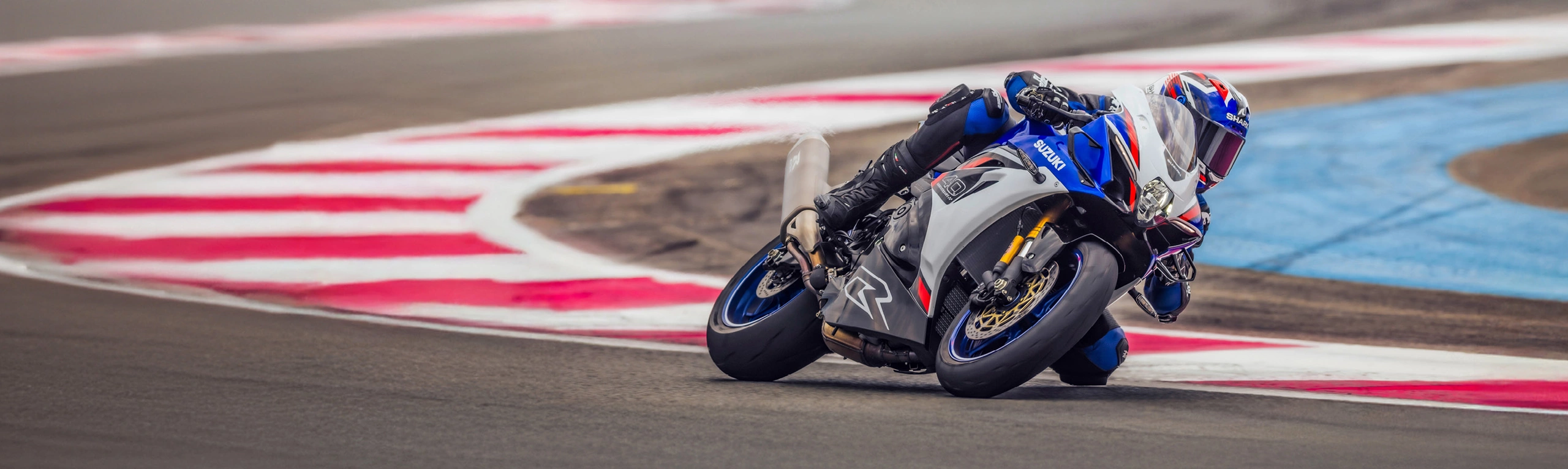 Suzuki GSX-R1000R blue pushing hard round a corner on track