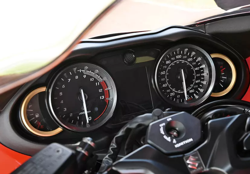 Close-up view of the Suzuki 25th anniversary Hayabusa’s dashboard, featuring speedometer and tachometer with gold accents.