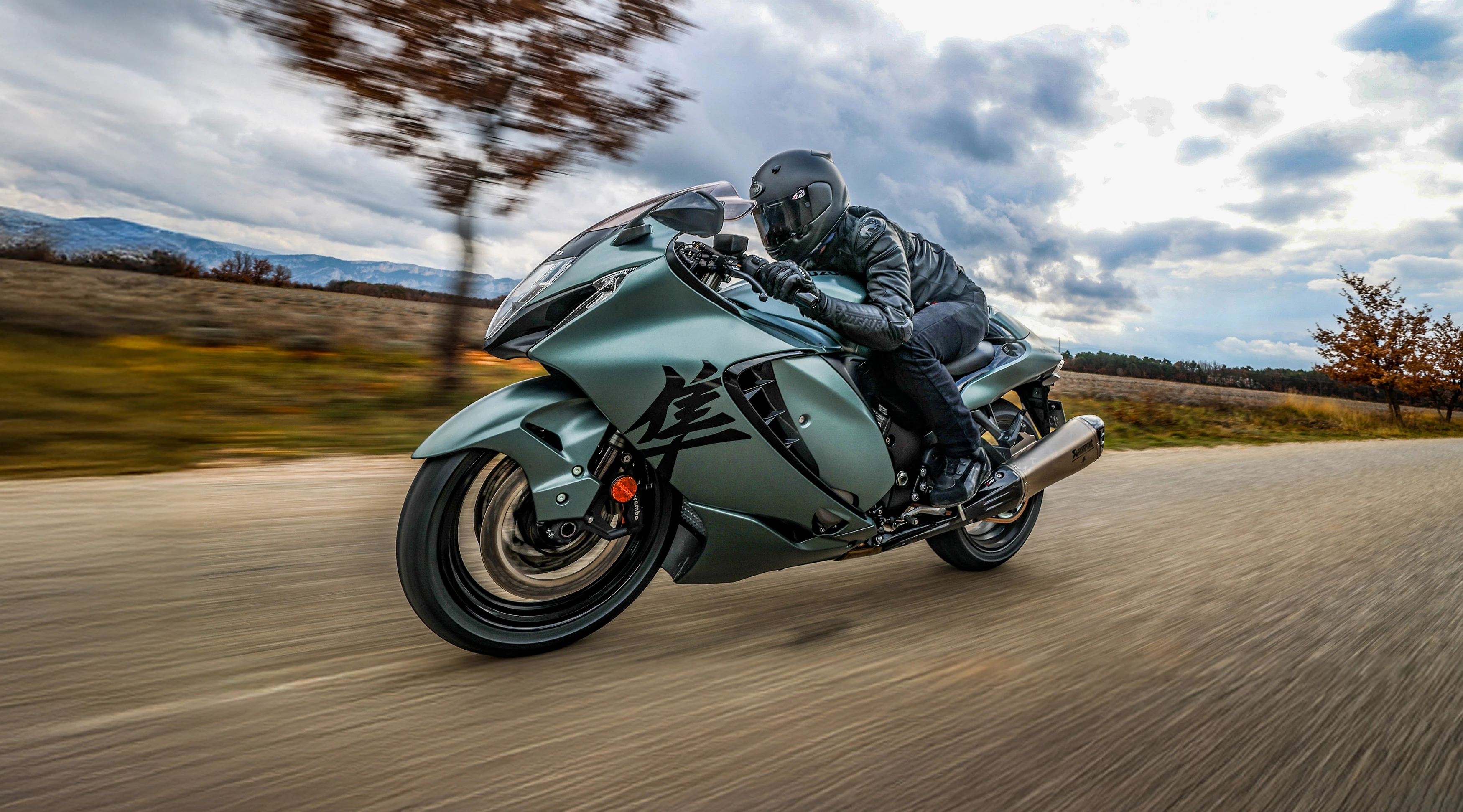 Suzuki Hayabusa riding dow a country road.