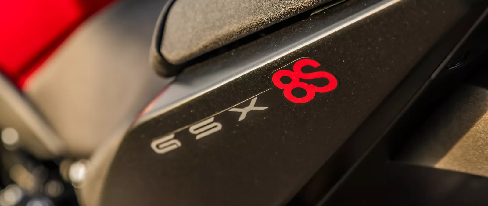 Suzuki GSX-8S red and black close up of the seat unit and GSX-8S logo