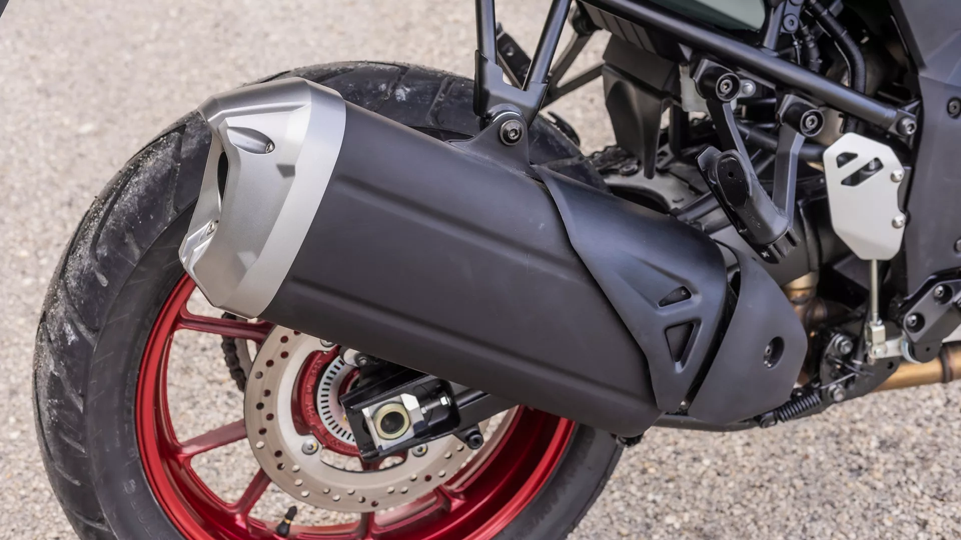 Suzuki V-Strom 1050RE close-up of the rear wheel and exhaust unit