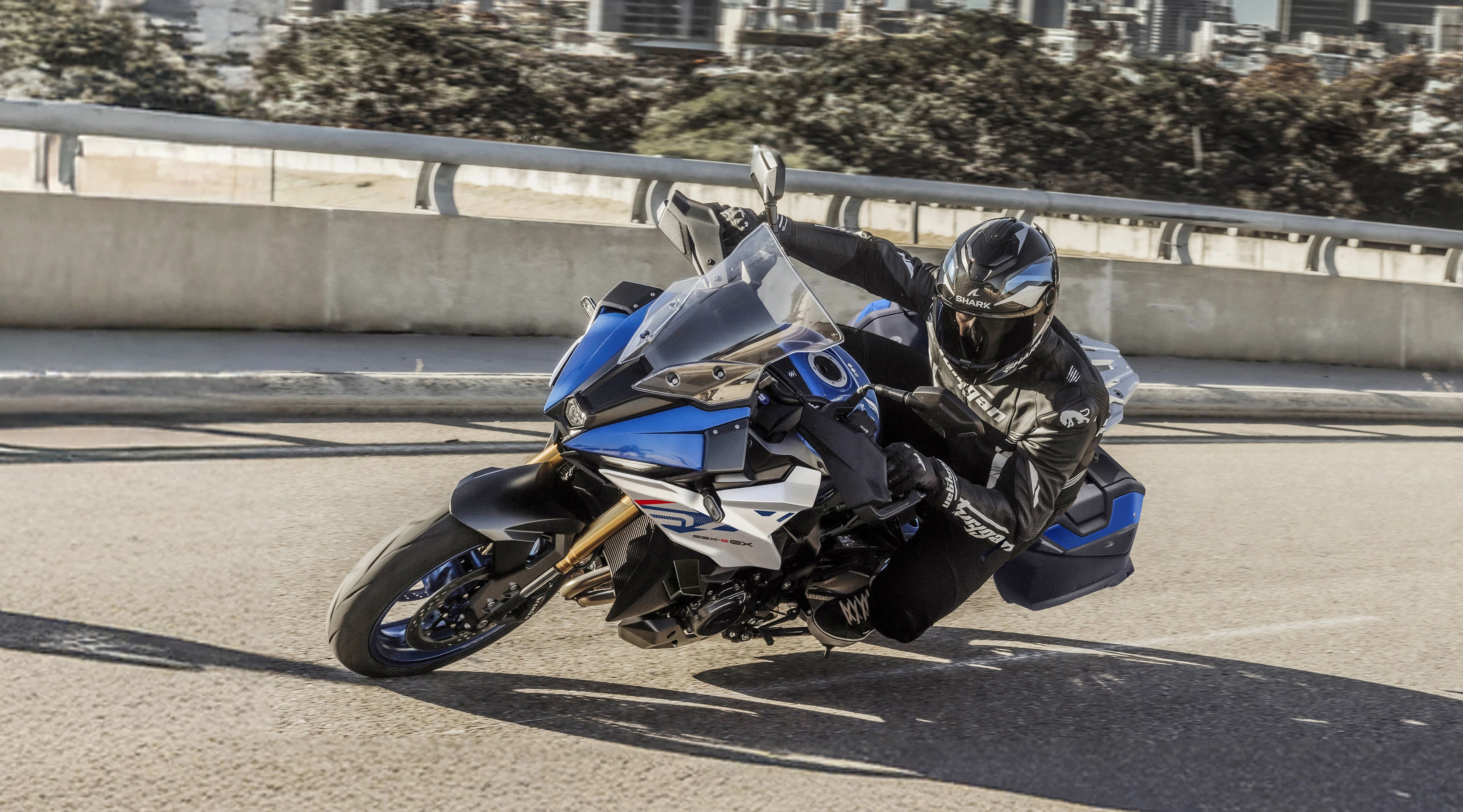 Suzuki GSX-S1000GX+ leaning hard into a corner