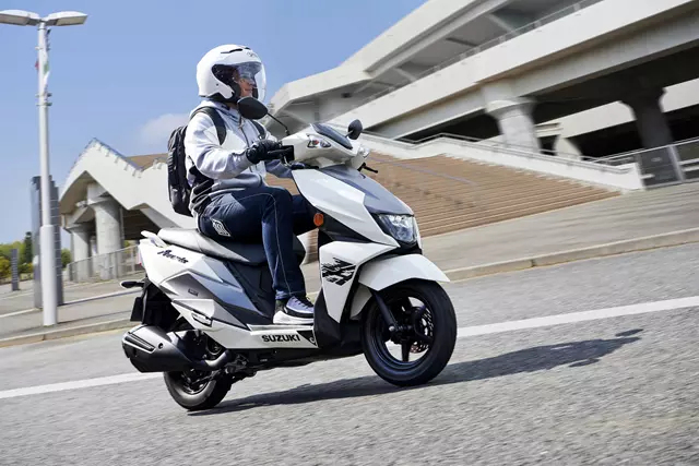 Suzuki Avenis heading along a city street 