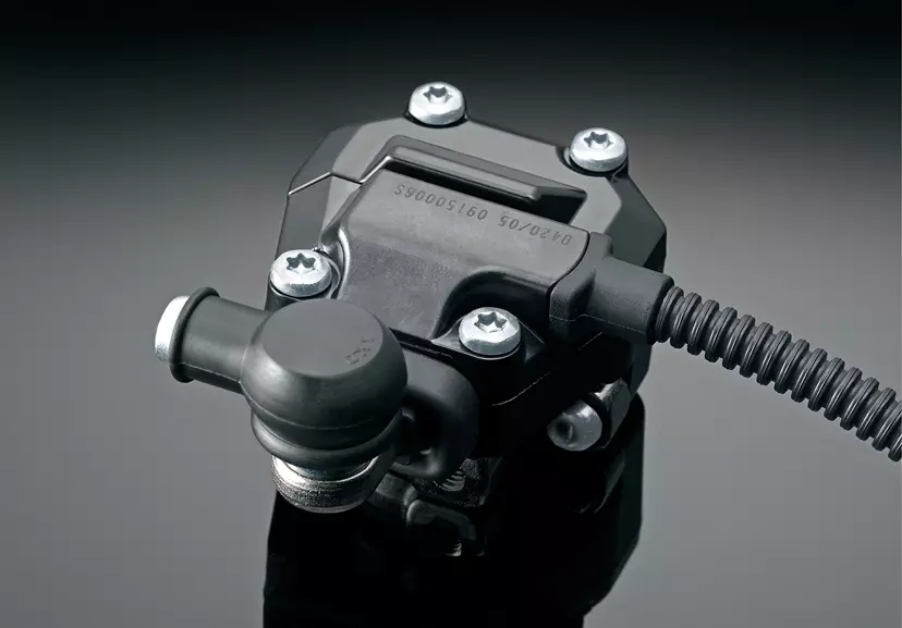 Suzuki GSX-S1000 bif-directional quickshifter unit close up with a grey studio background