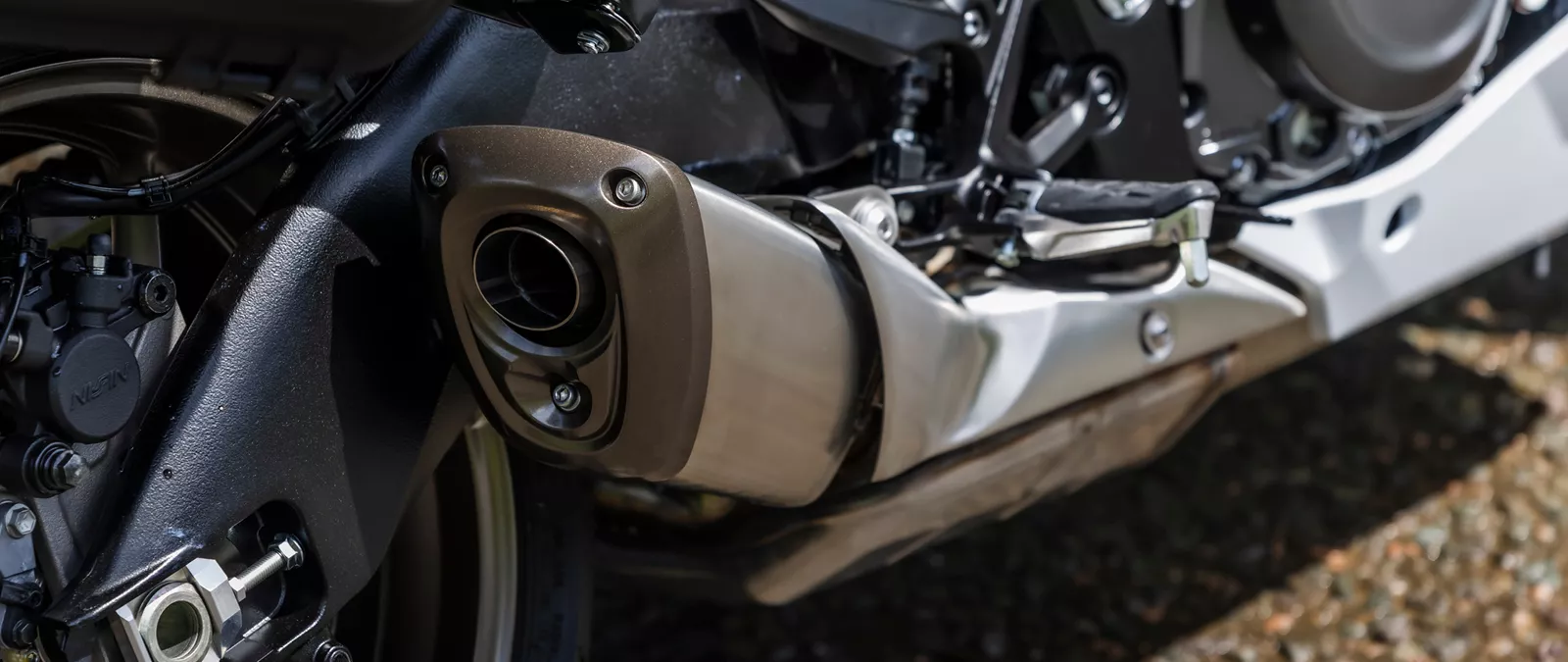 Suzuki GSX-S1000GT+ close up of the exhaust and engine from behind the exhaust
