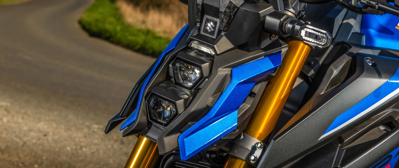 Suzuki GSX-S1000 blue front headlight cluster close up, on location