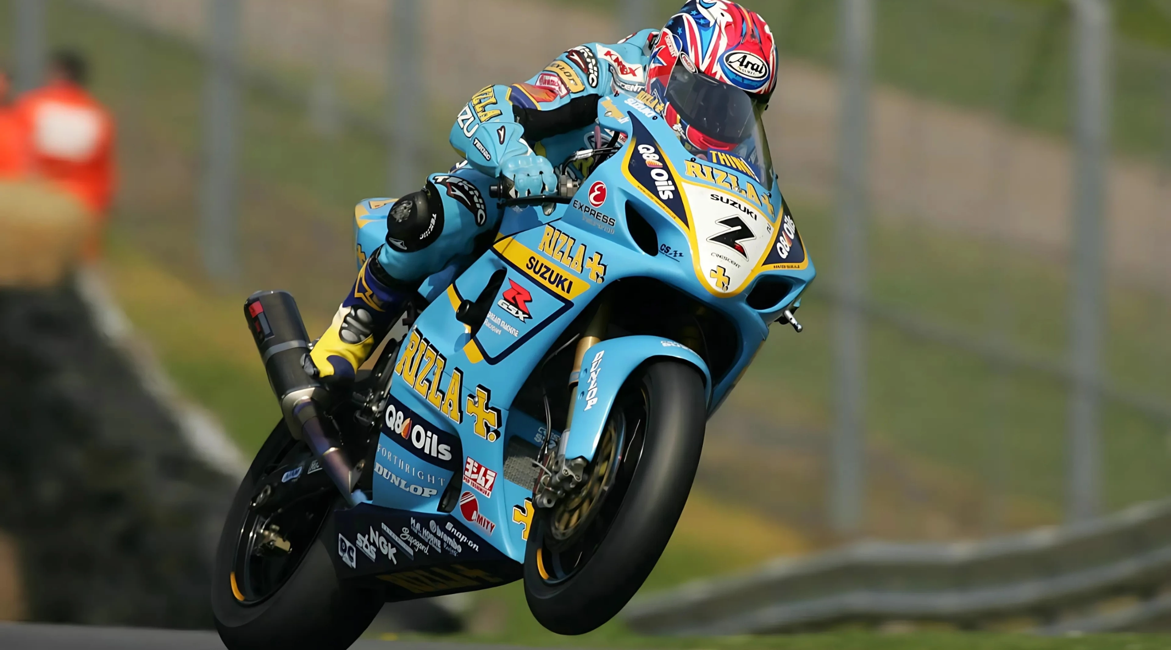 Suzuki GSX-R1000 race bike wheeling over a hill