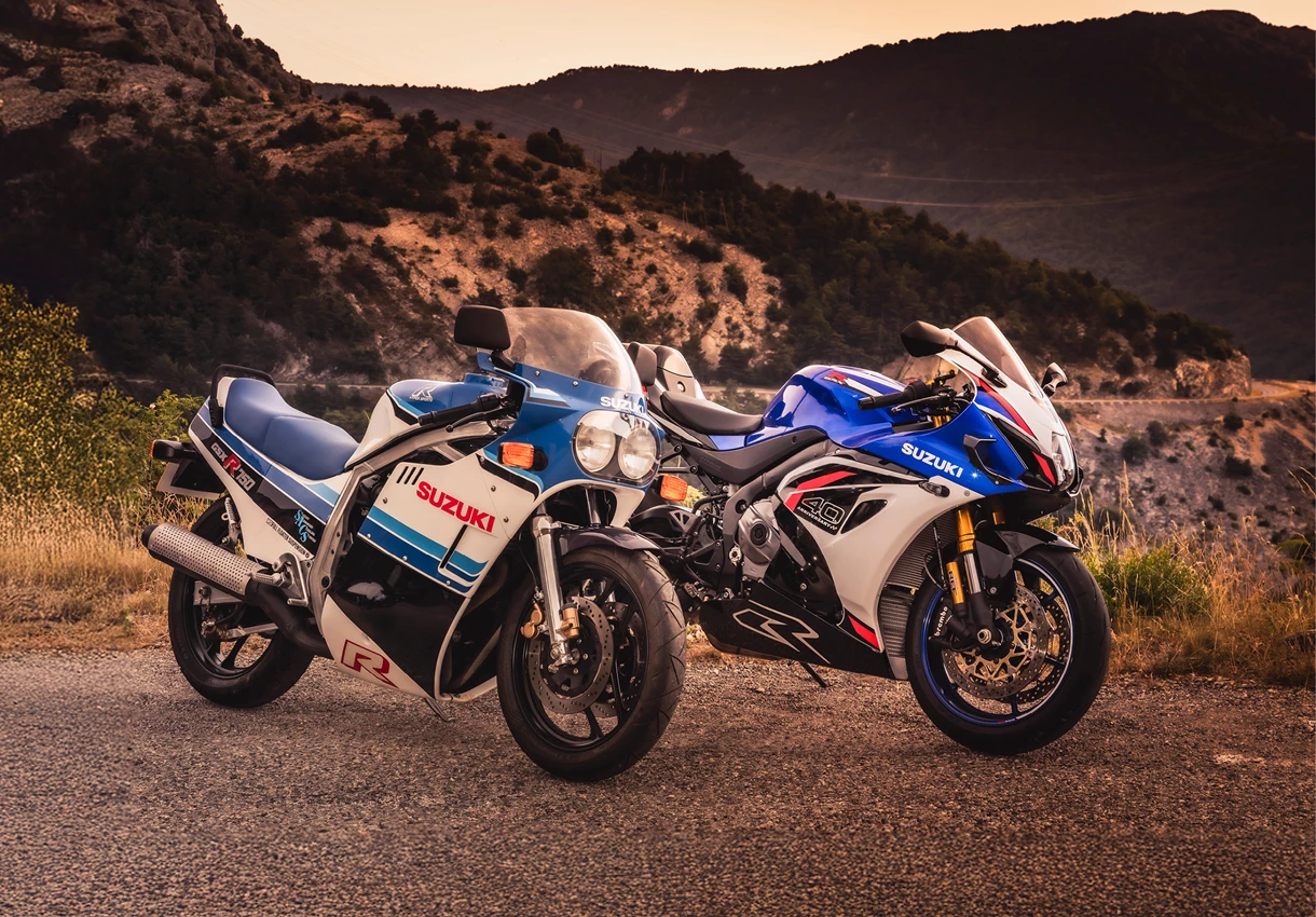 Suzuki GSX-R1000R and classic GSX-R on a mountain side road at dusk