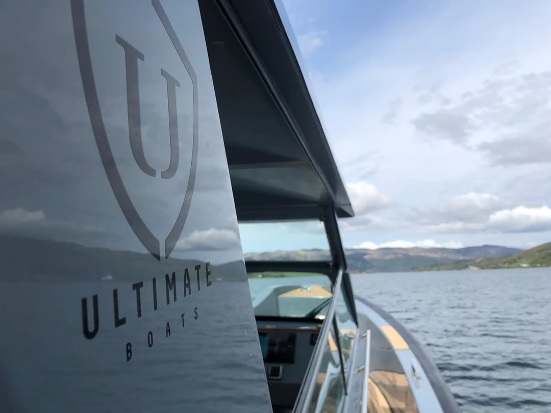 Side of boat with Ultimate Boats logo