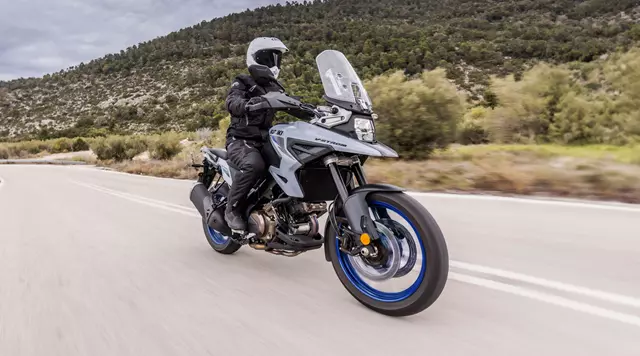 Suzuki V-Strom 1050 blasting along a mountain pass.