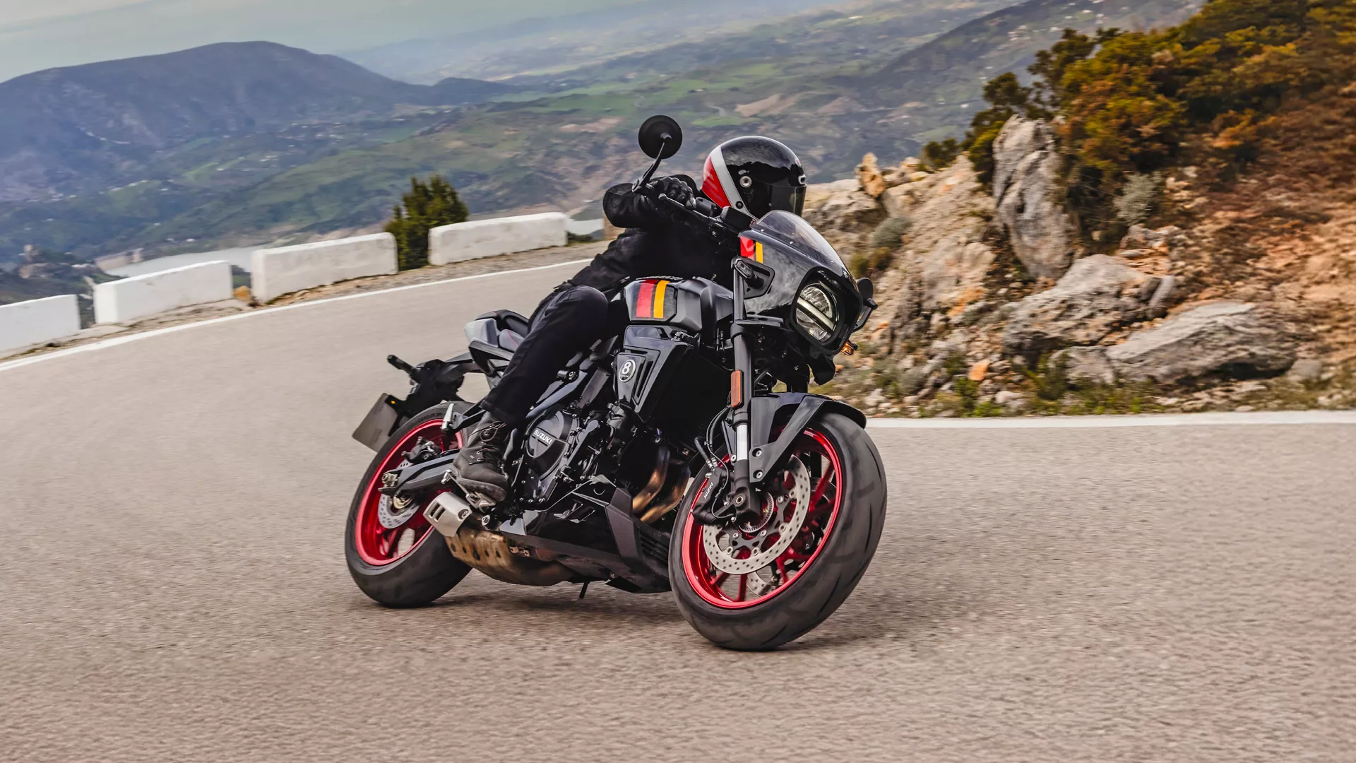 Suzuki GSX-8TT black, pushing on through a corner on a mountain road