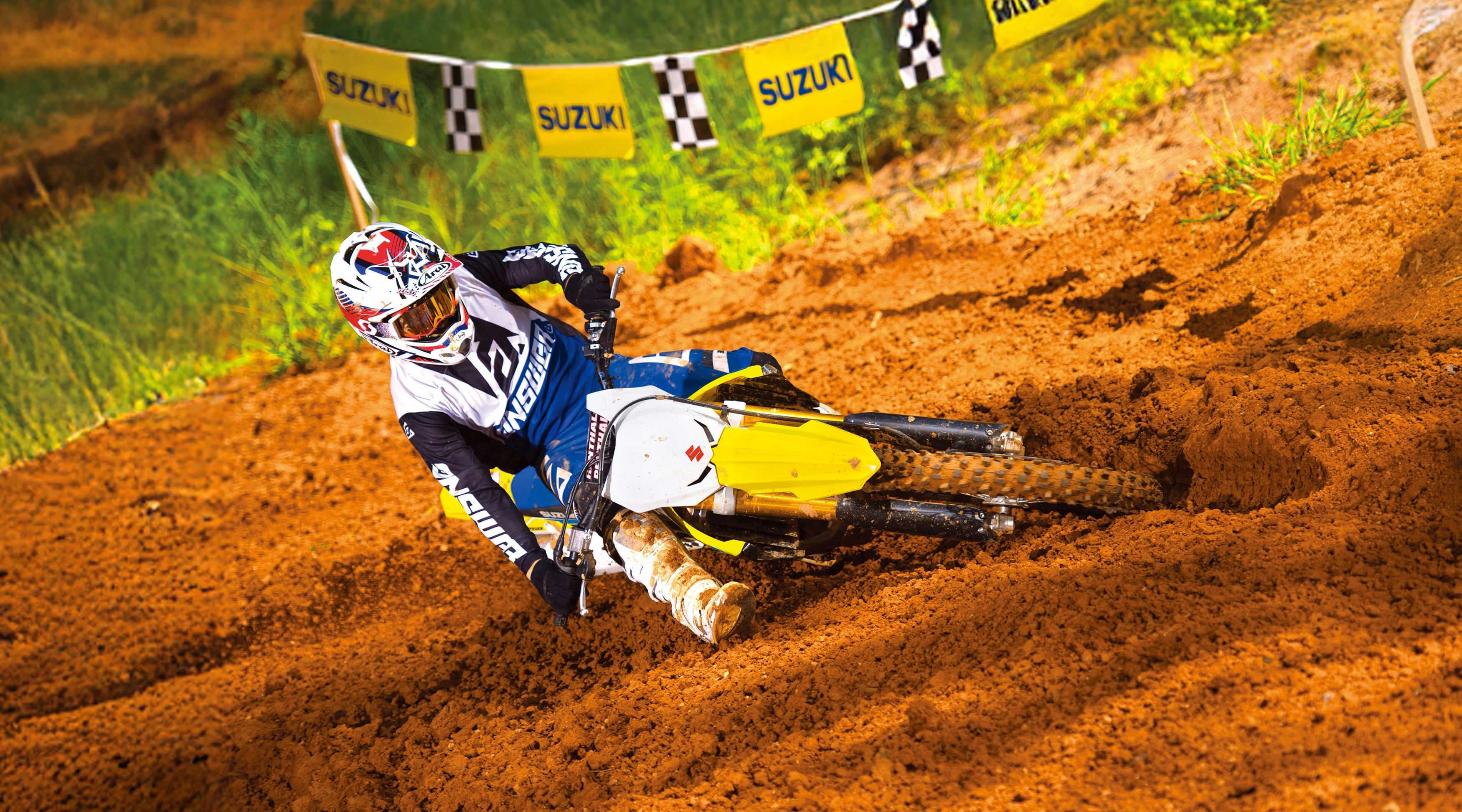 Suzuki RM-Z250 leaning heavily into a corner on a Motorcross track