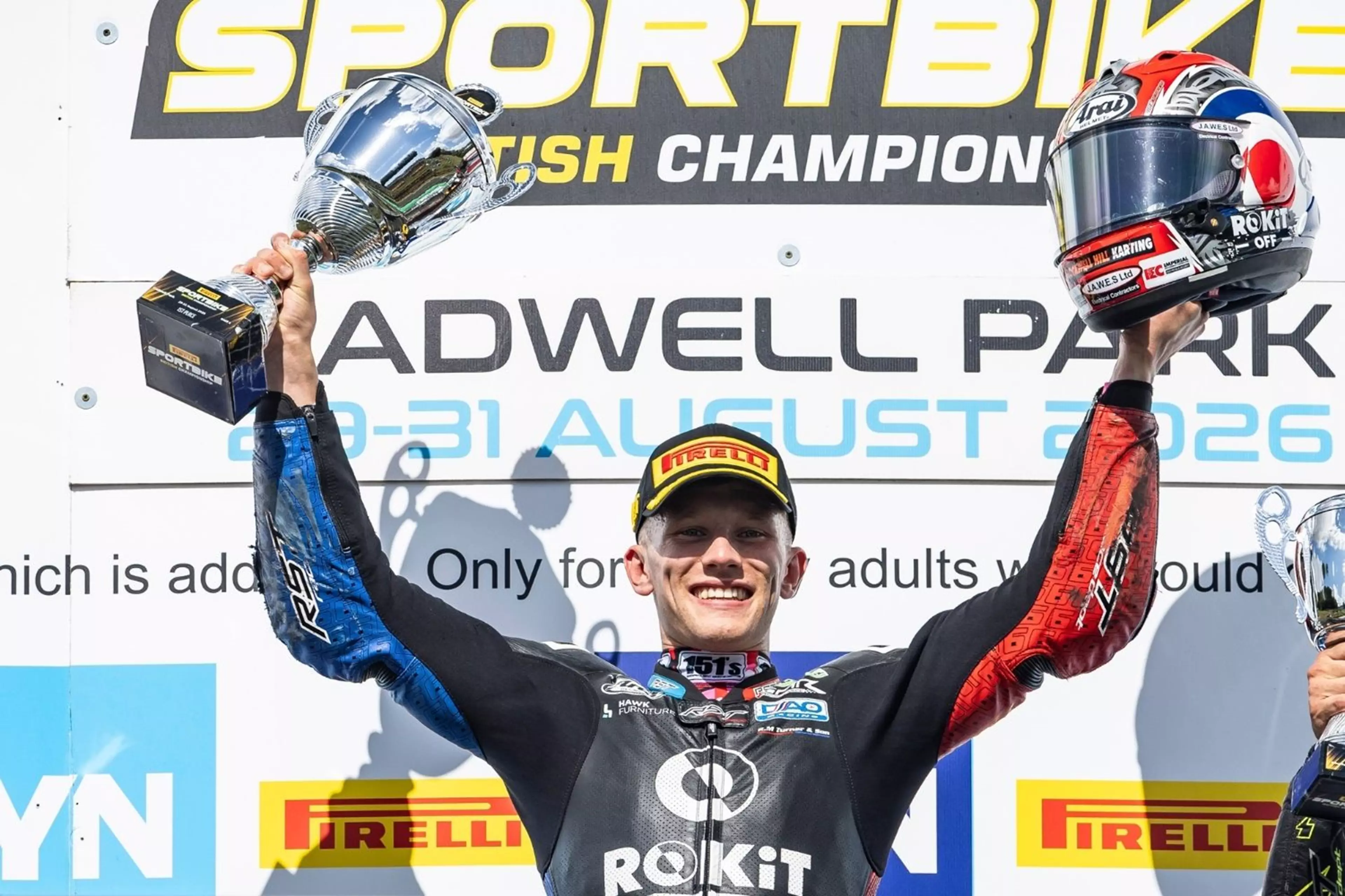 Carl Harris celebrating on the Sportbike podium at Cadwell Park