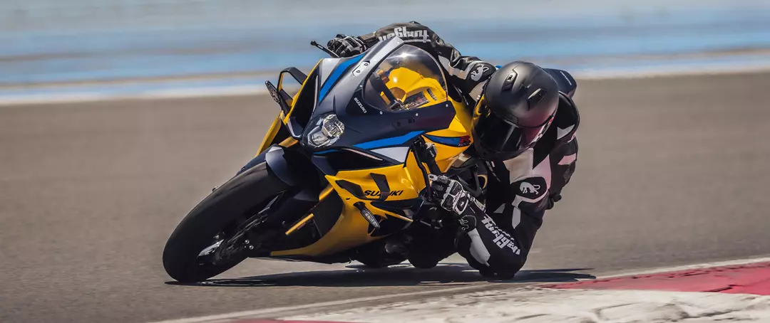 Suzuki GSX-R1000R fully lent over in a corner on track.