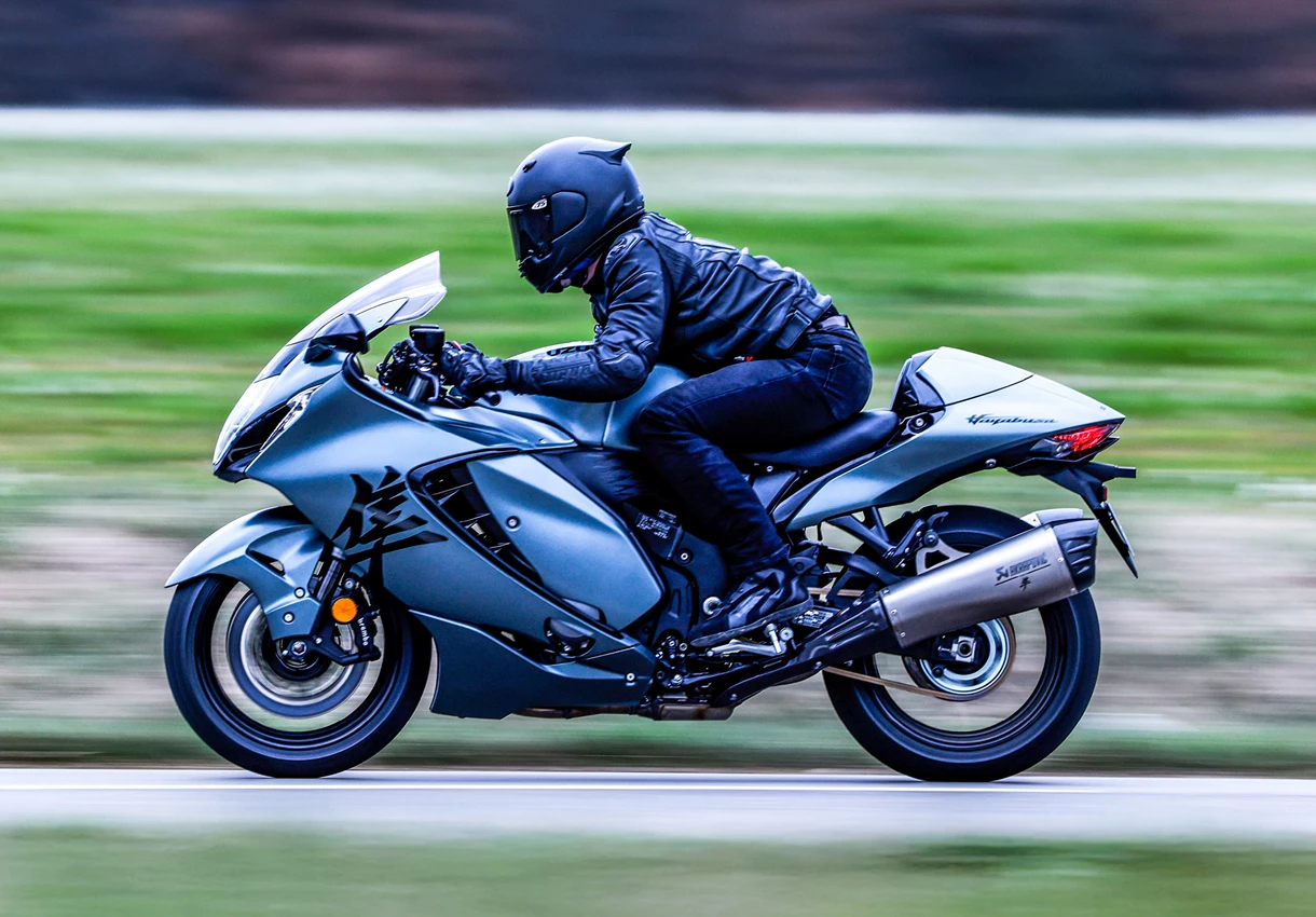 Suzuki Hayabusa left hand side pushing on along a country road.