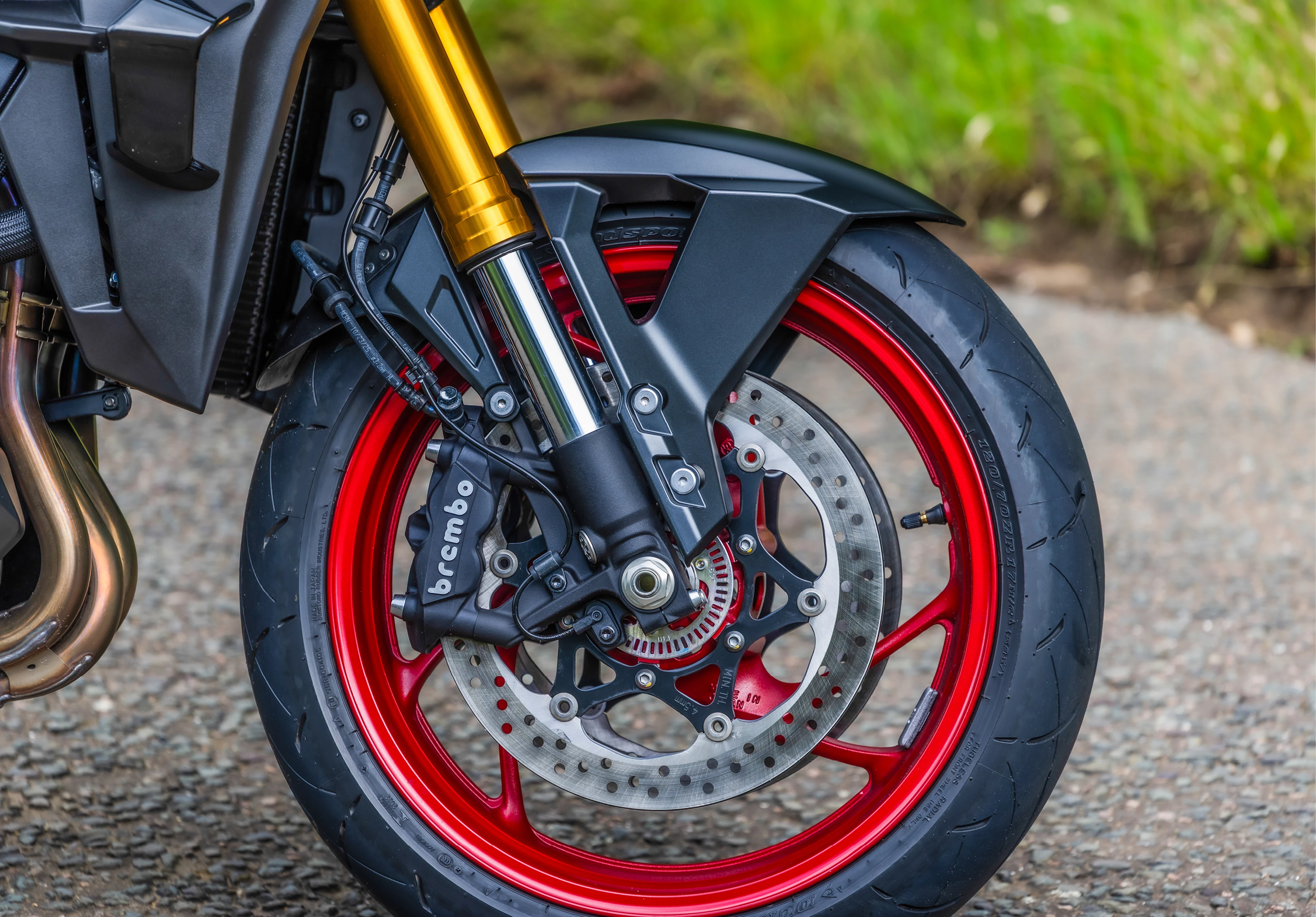 Suzuki GSX-S1000GX+ front wheel and brakes close-up.