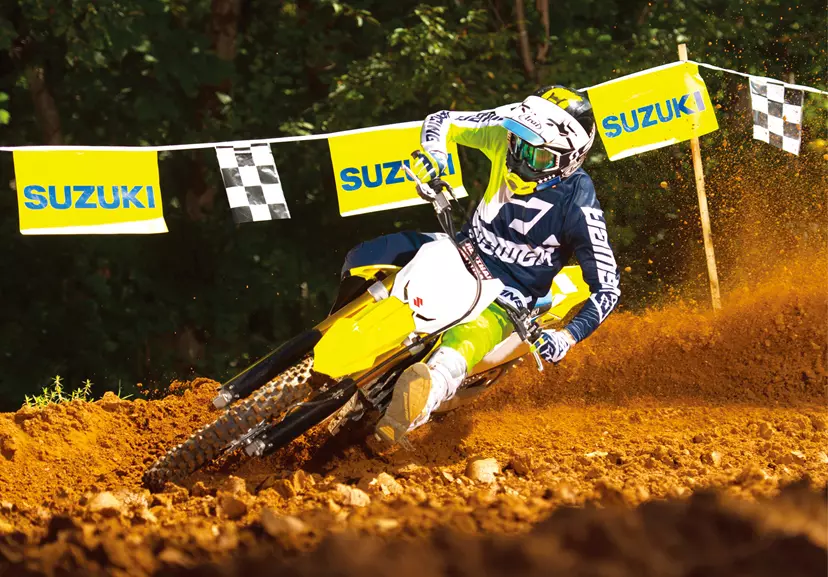 Suzuki RM-Z450 leant over backing in hard going around a corner on a Motocross track