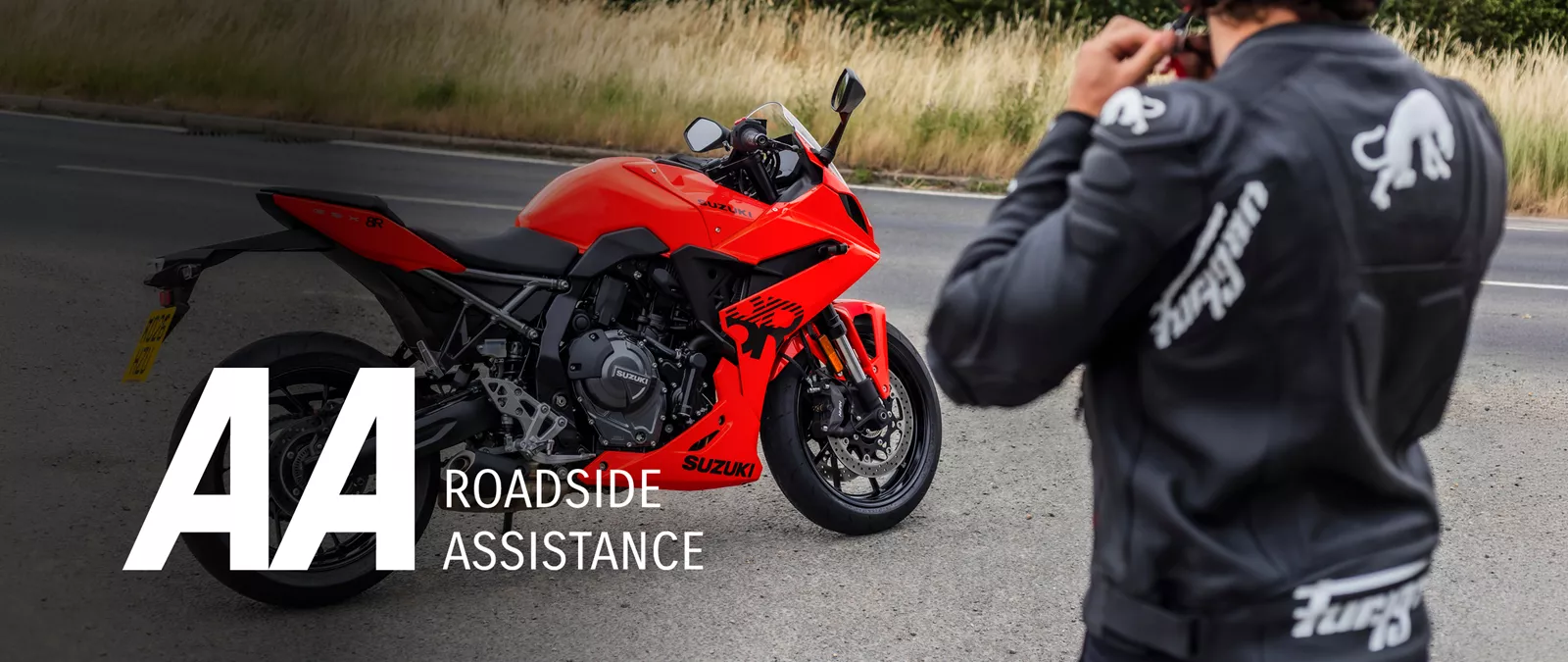 Suzuki GSX-8R orange right hand side static with a ride putting on their helmet with fields behind