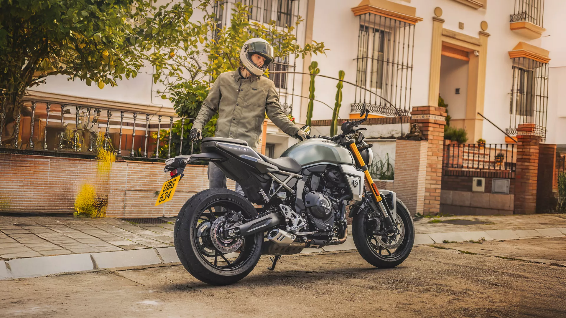 Suzuki GSX-8T green, right hand side static with rider behind on location