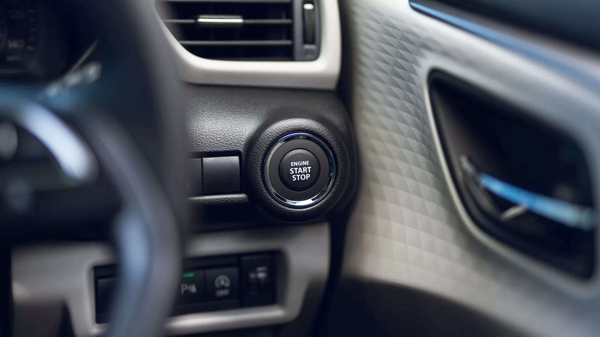 Close-up of the Suzuki Swift interior showing the Engine Start Stop button for keyless entry and push-button start functionality