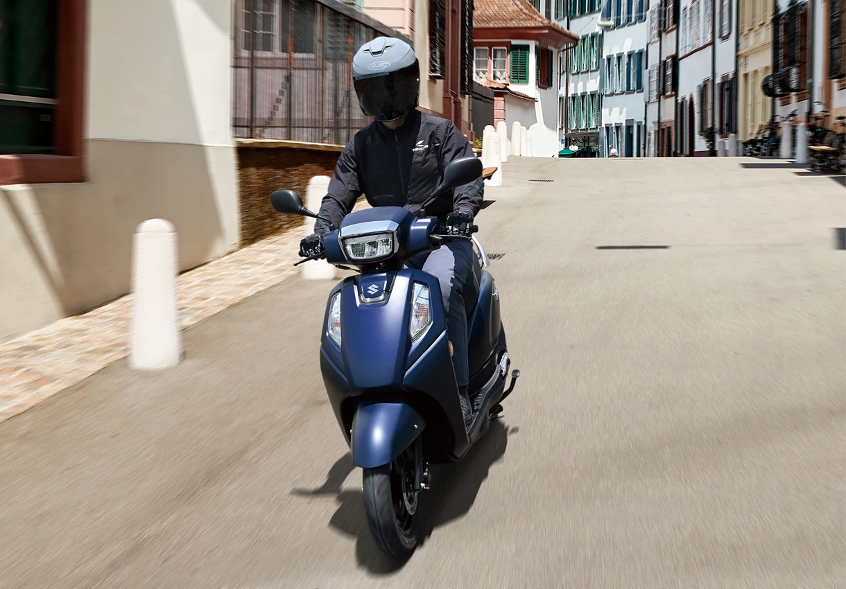 Suzuki Address 125 scooter driving through a city