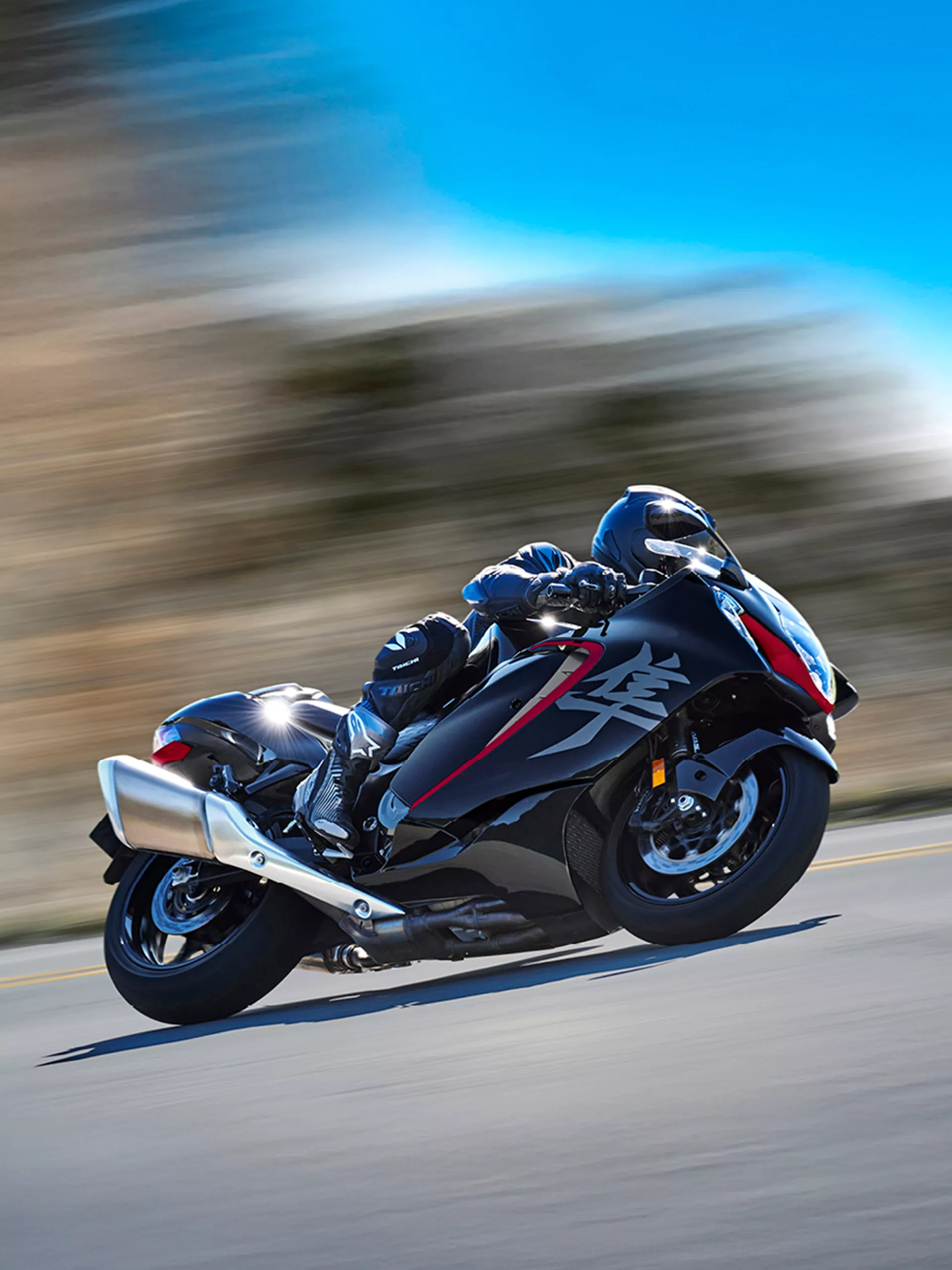 Suzuki Hayabusa leaning into to a corner with a blurred tree liens background