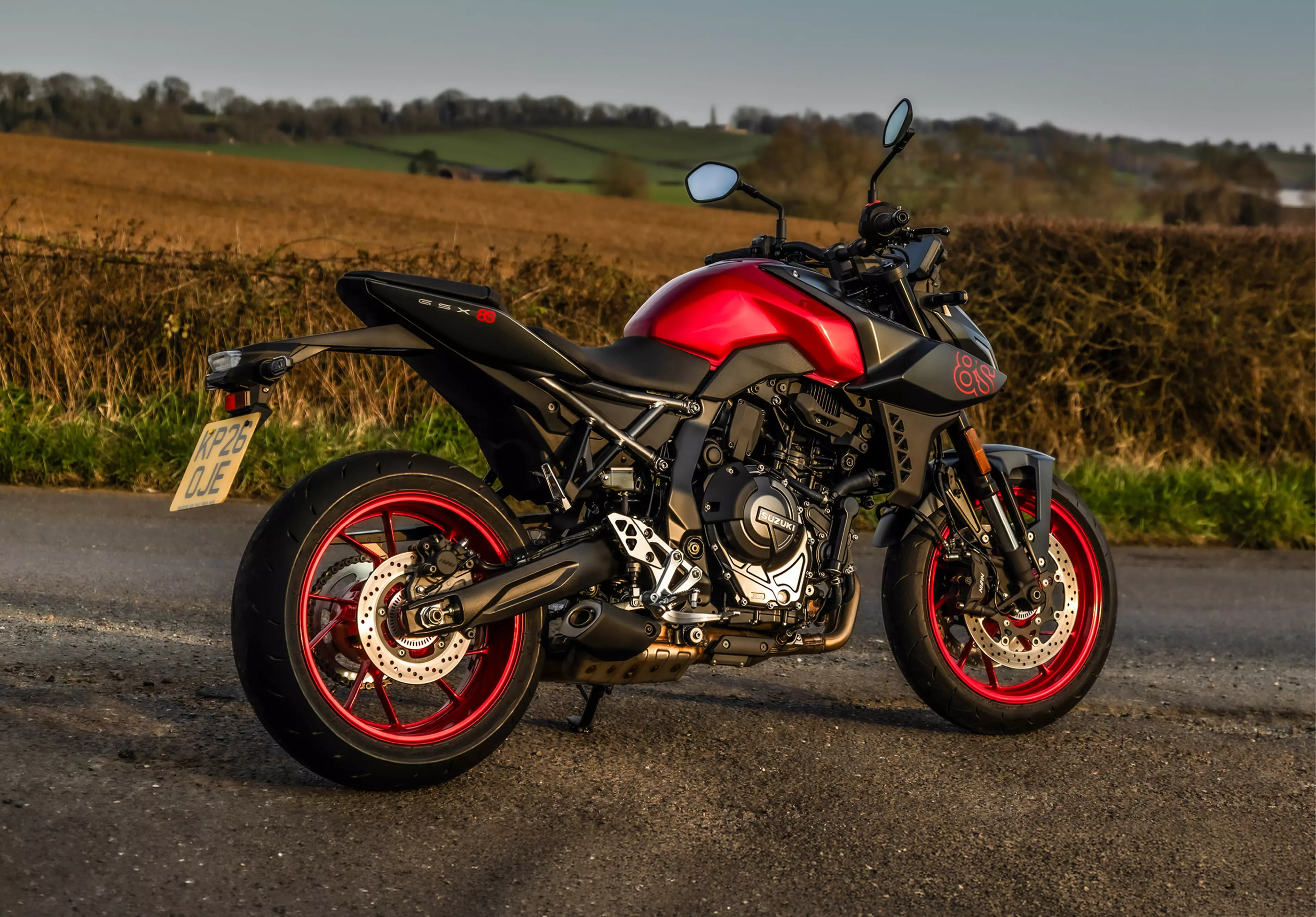 Suzuki GSX-8S red and black, static with a countryside background