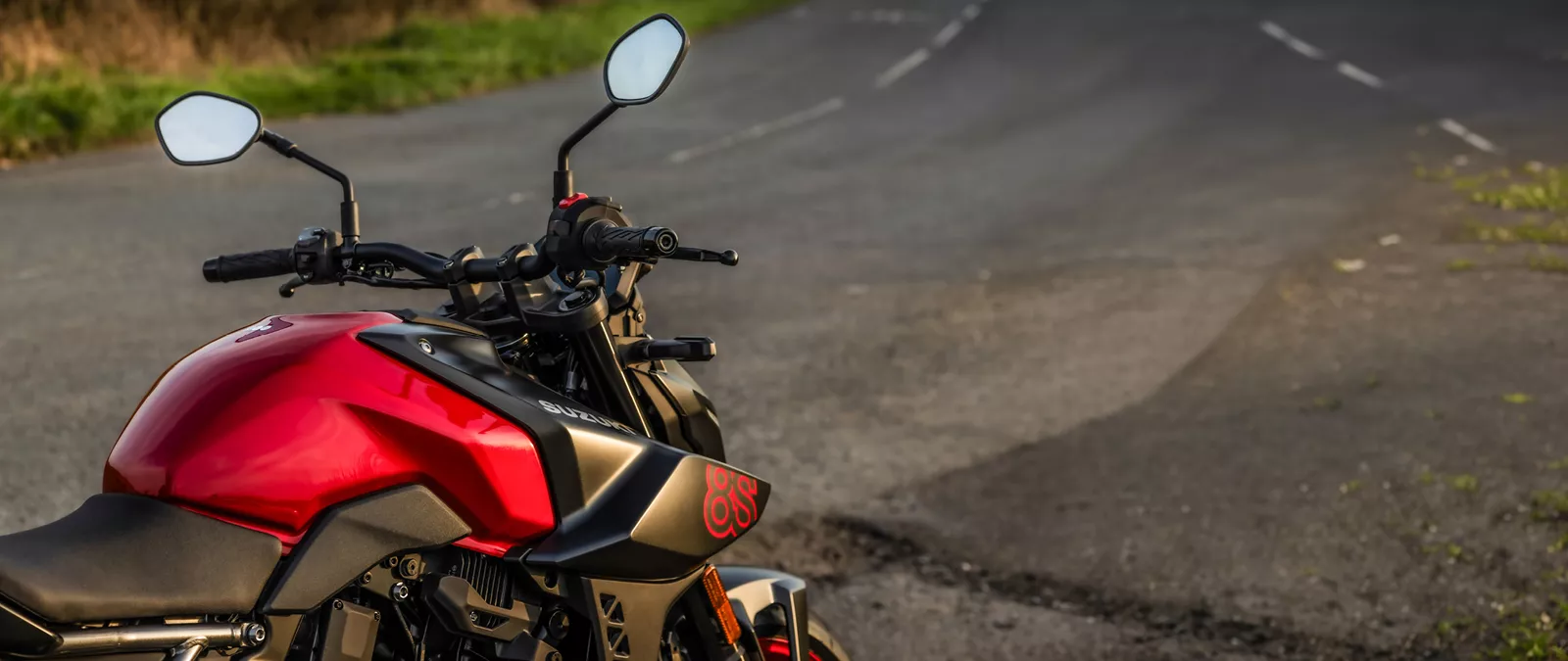 Suzuki GSX-8S red and black right hand side tank and bars close up at the roadside