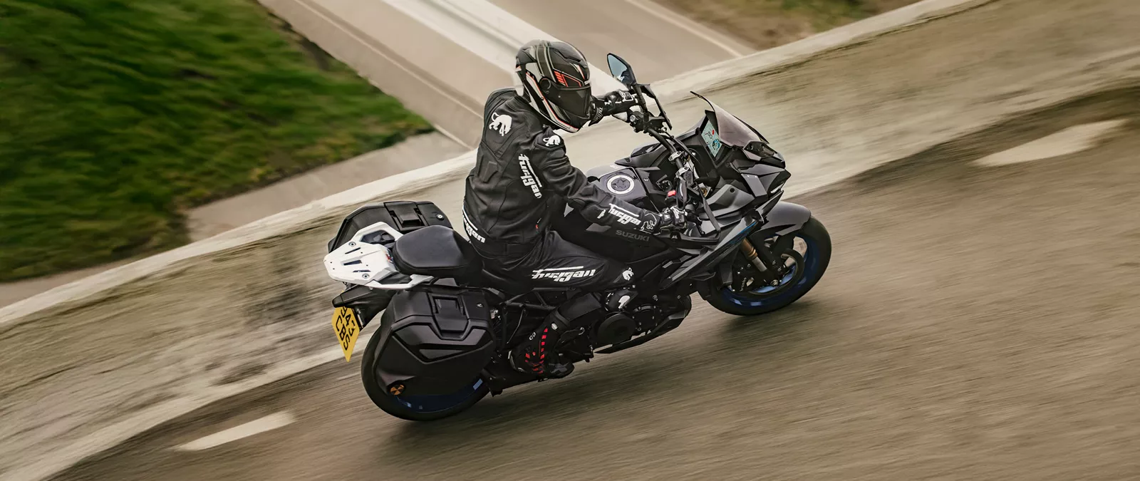 Suzuki GSX-S1000GX+ riding over a bridge with water underneath